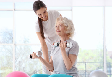 elderly woman exercise with caretaker