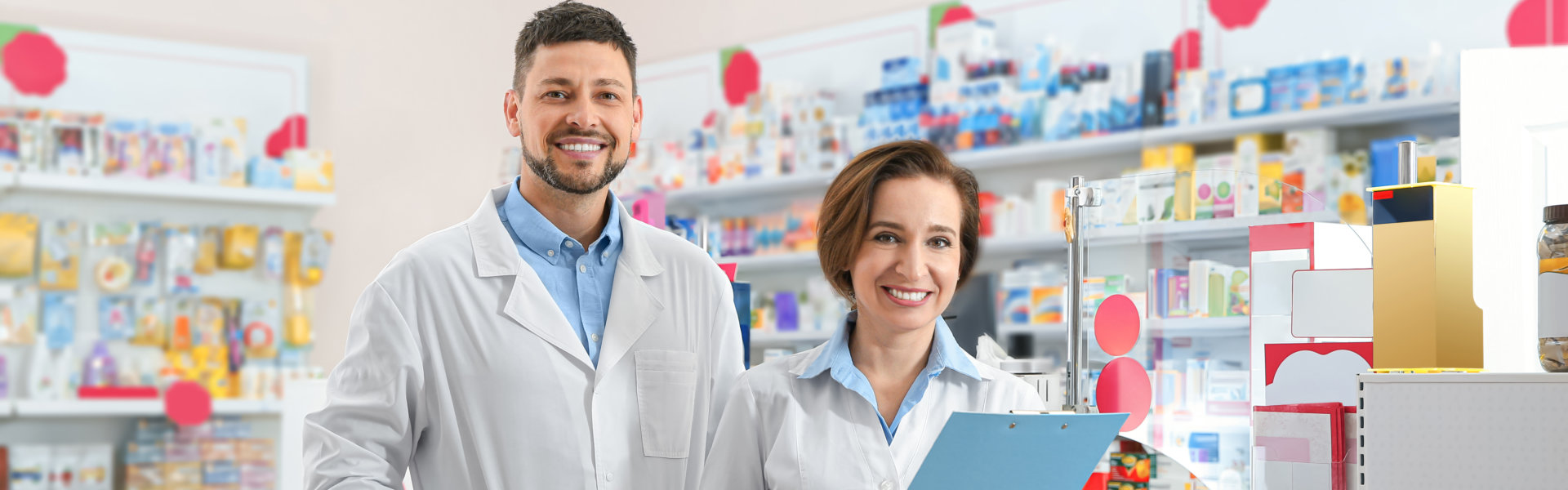 Portrait of professional pharmacists in modern drugstore